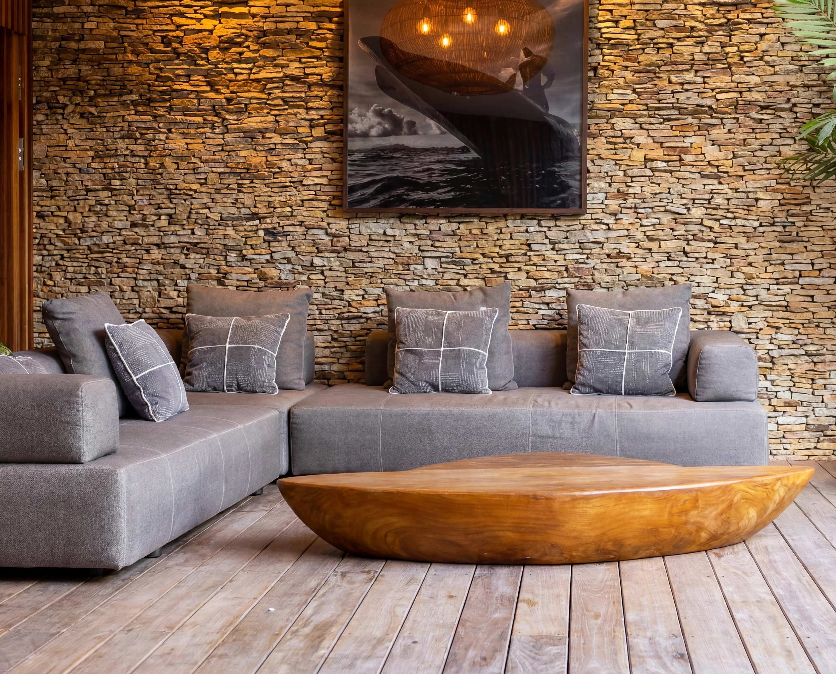 living room grey sofa stone wall