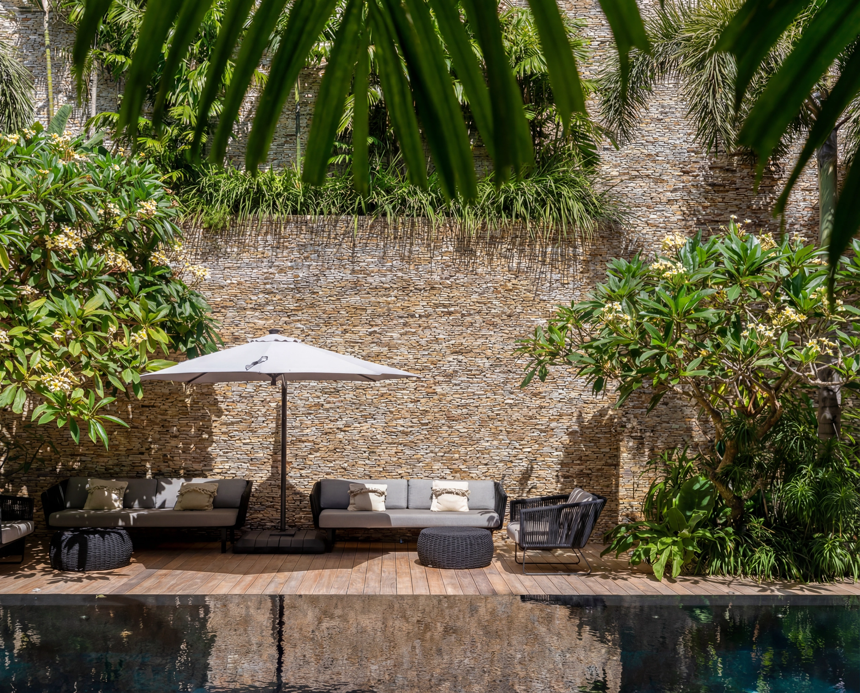 pool deck umbrella stone wall