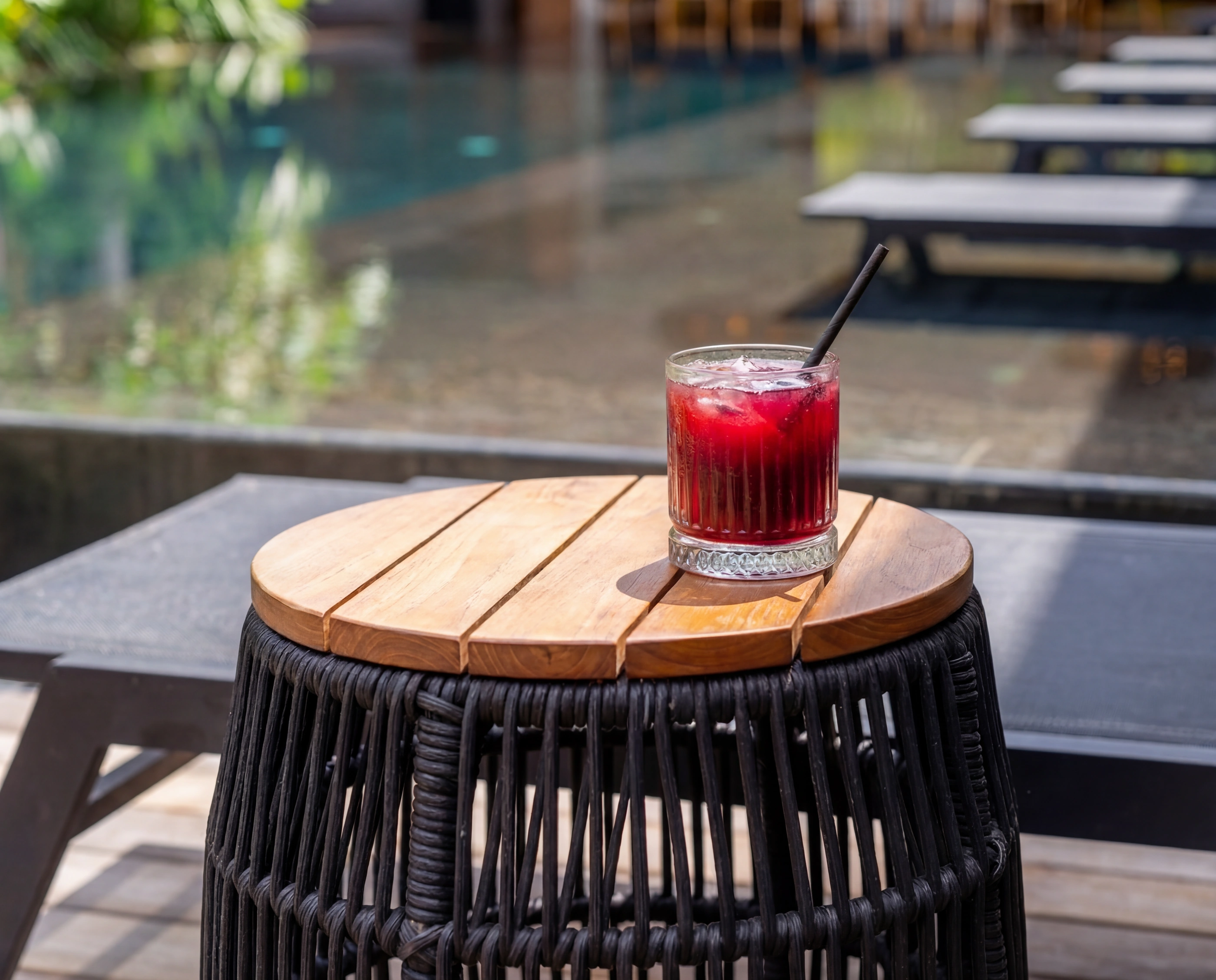 poolside red drink wood table