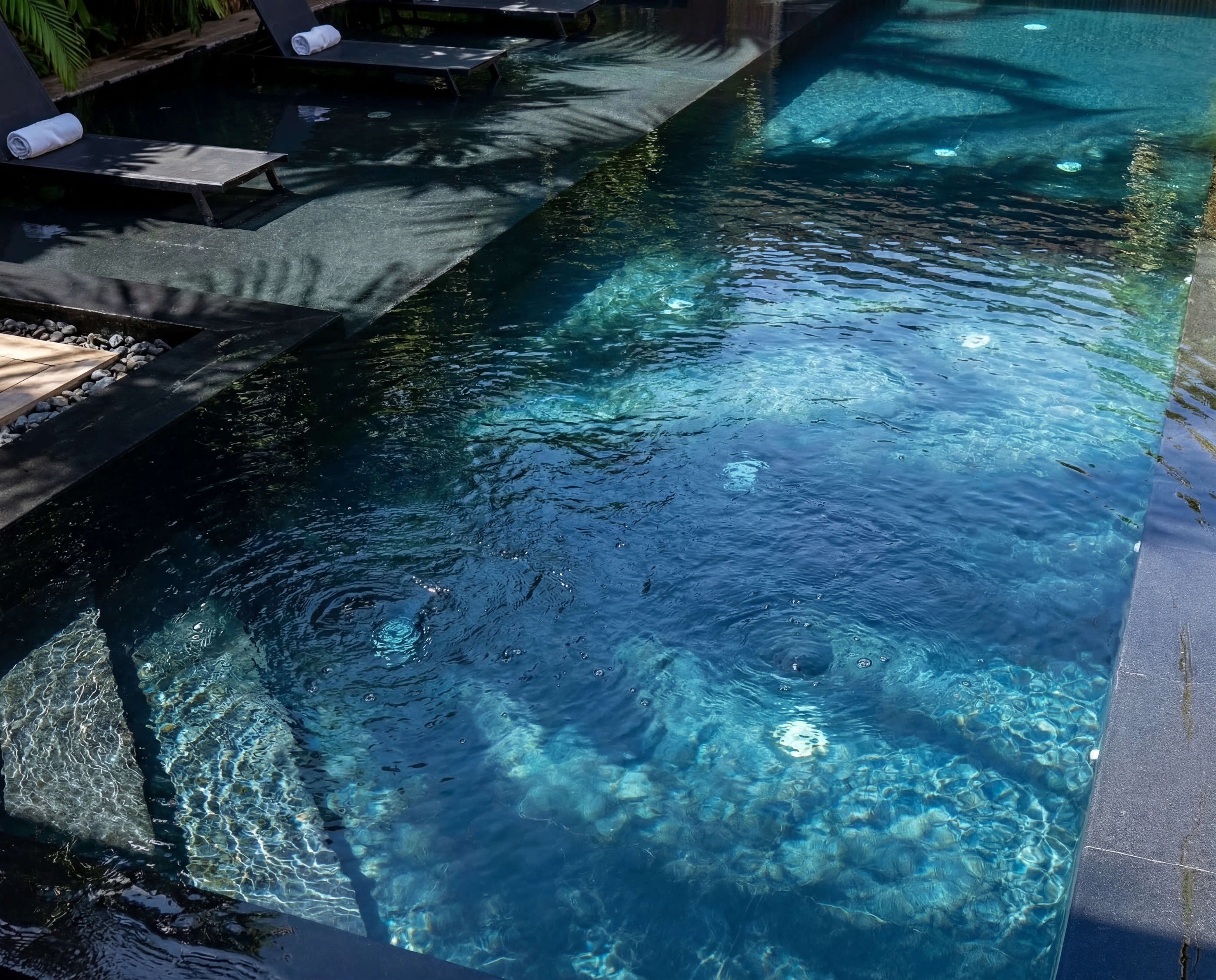 pool water loungers dappled shade